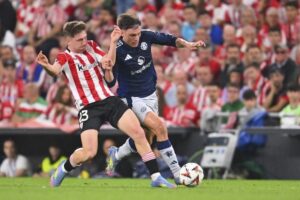 Mikel Jauregizar berduel dengan Manuel Ugarte dalam laga Athletic Bilbao vs Manchester United di leg pertama semifinal Liga Europa 2024/2025, Jumat (2/5/2025) dini hari WIB. (c) AP Photo/Miguel Oses